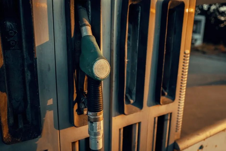 A detailed view of a gas pump nozzle during sunset in Österreich, highlighting industrial design.
