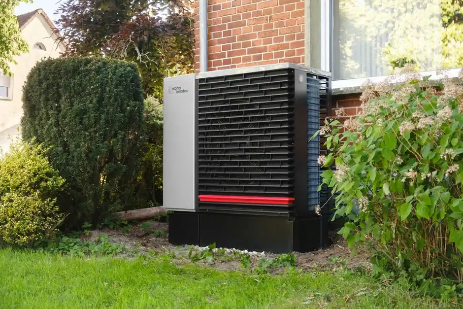 Energy-efficient heat pump in a green residential garden setting.